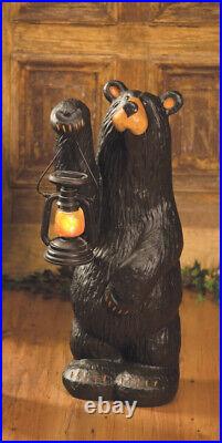 Black Bear Koleman holding a lantern by Jeff Fleming of Bearfoots Rustic Cabin